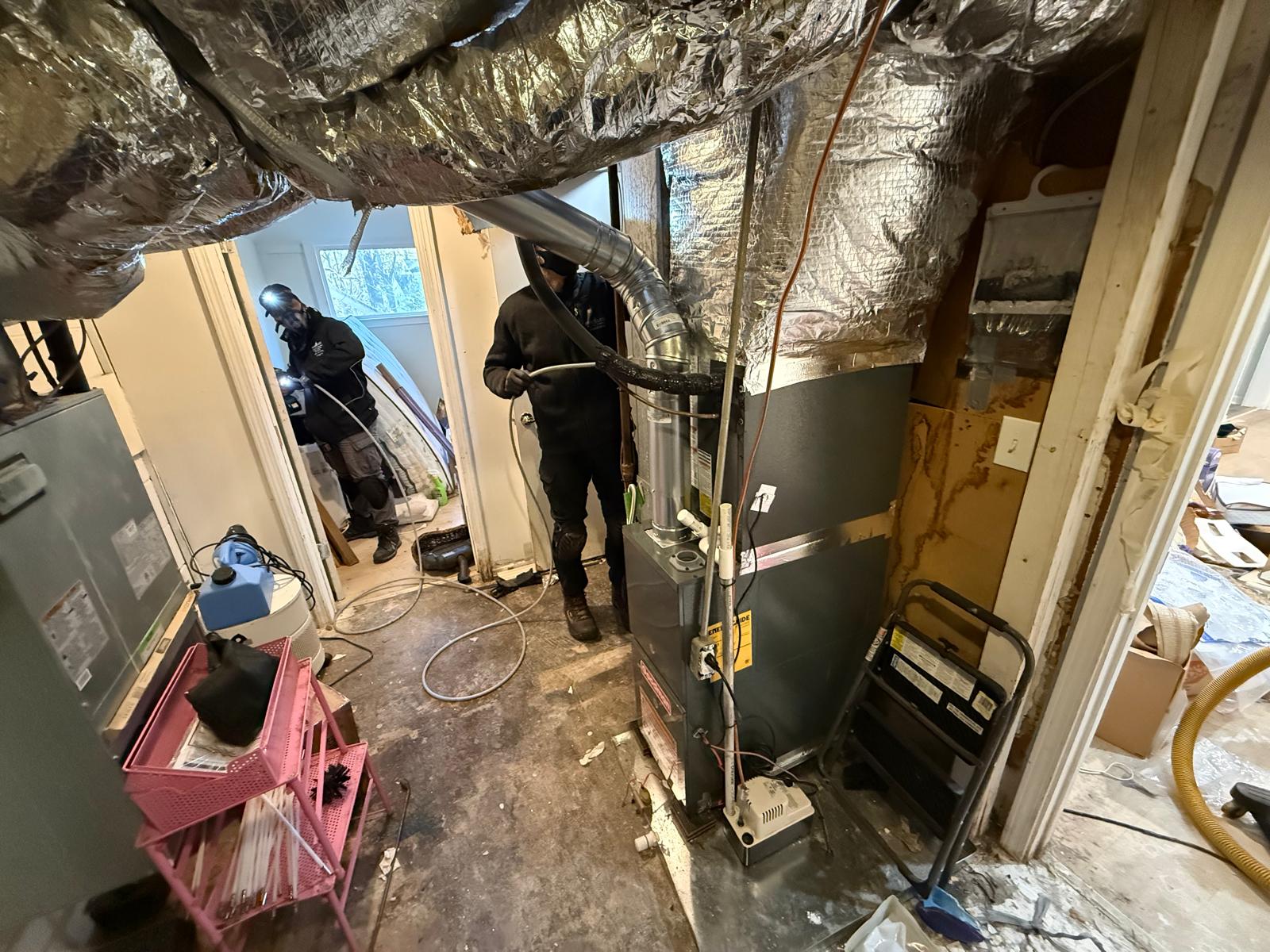 Basement mechanical room — furnace and supply trunk cleaning with whip-rod agitation