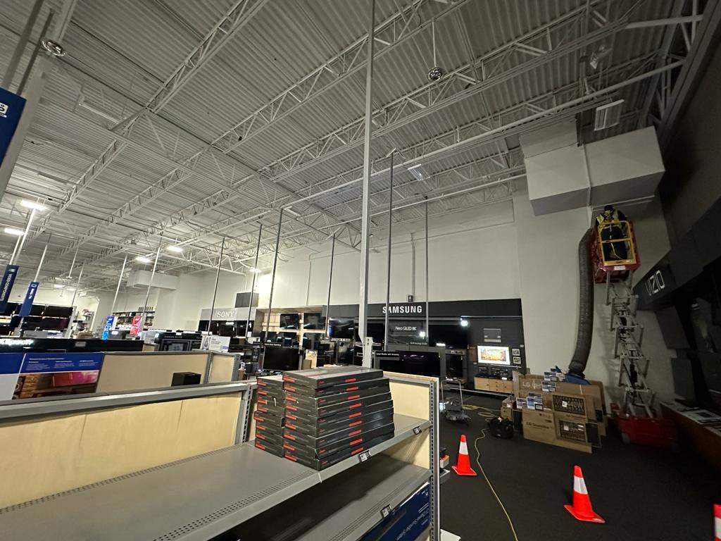 Electronics showroom — coned-off work zone across Samsung and Sony departments