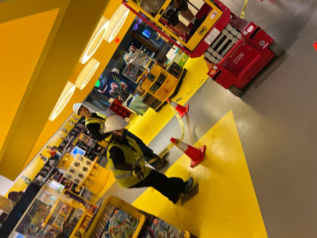 LEGO Store — crew coordinating coned-off work zone