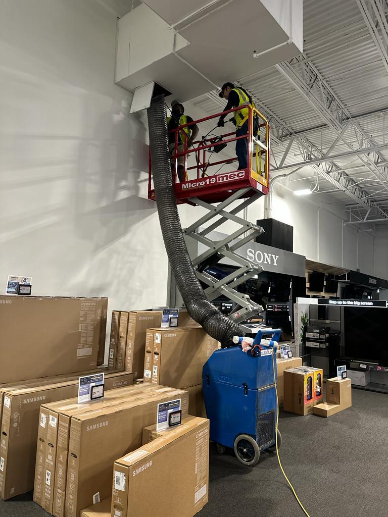 Electronics showroom — HEPA negative-air containment beside Samsung inventory