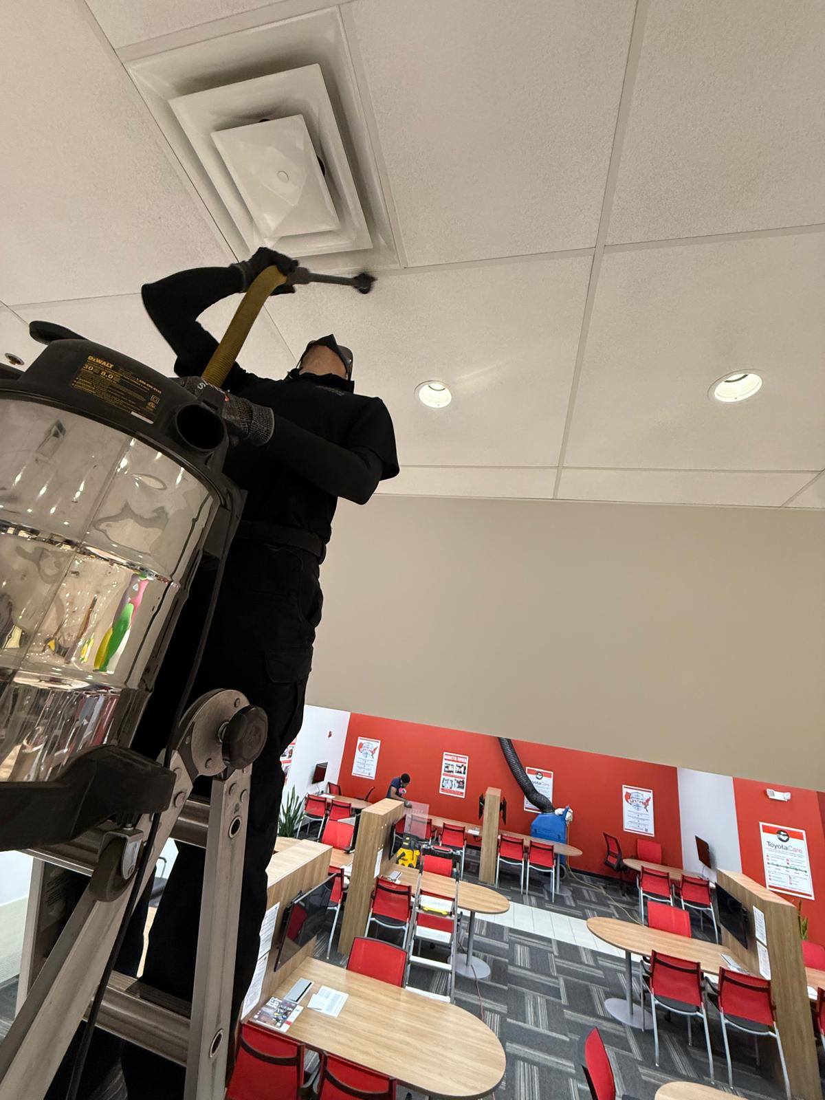 Toyota waiting area — whip-rod agitation on supply diffuser with HEPA capture
