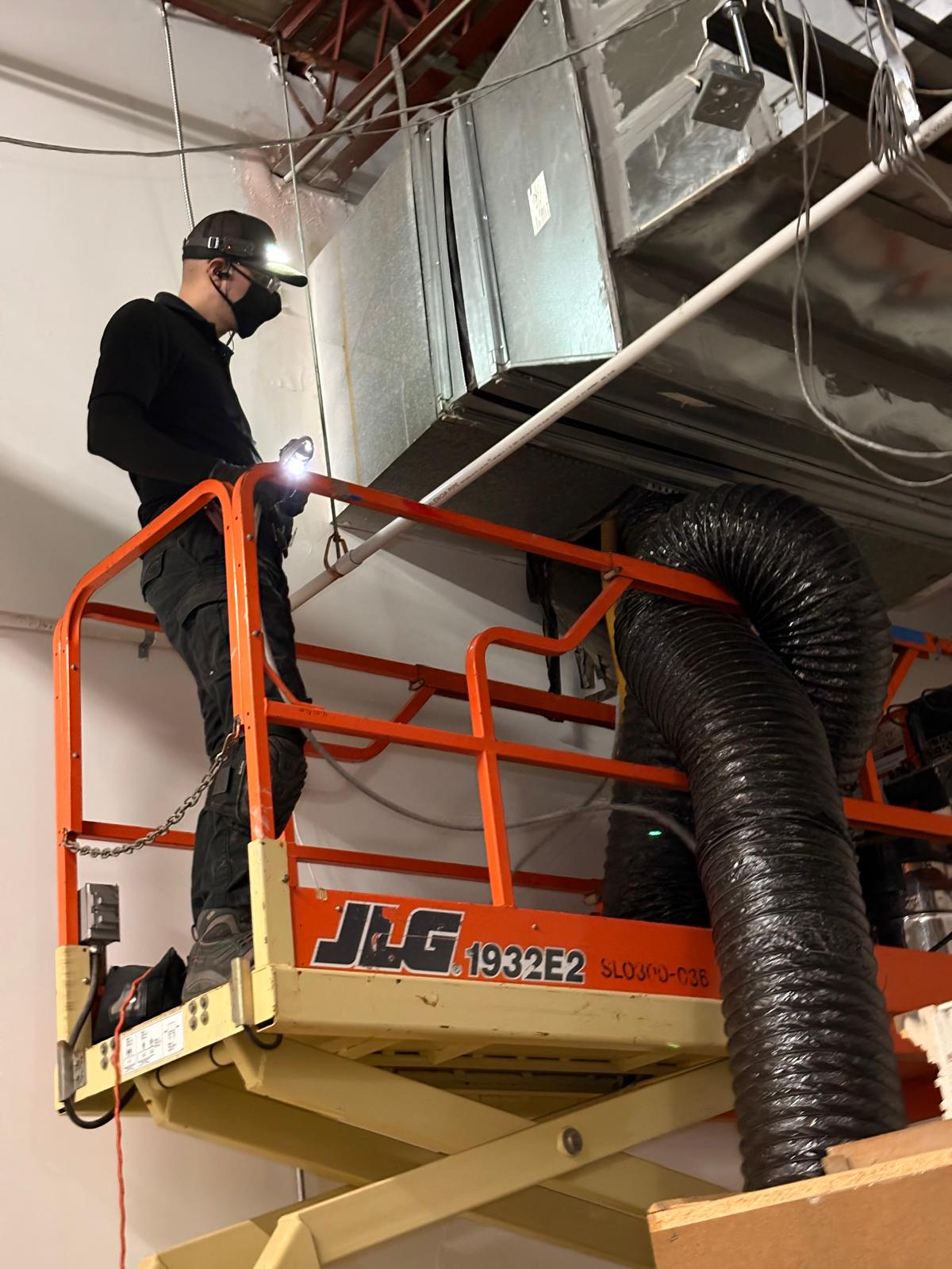 Warehouse HVAC — JLG 1932E2 lift work on insulated trunk line