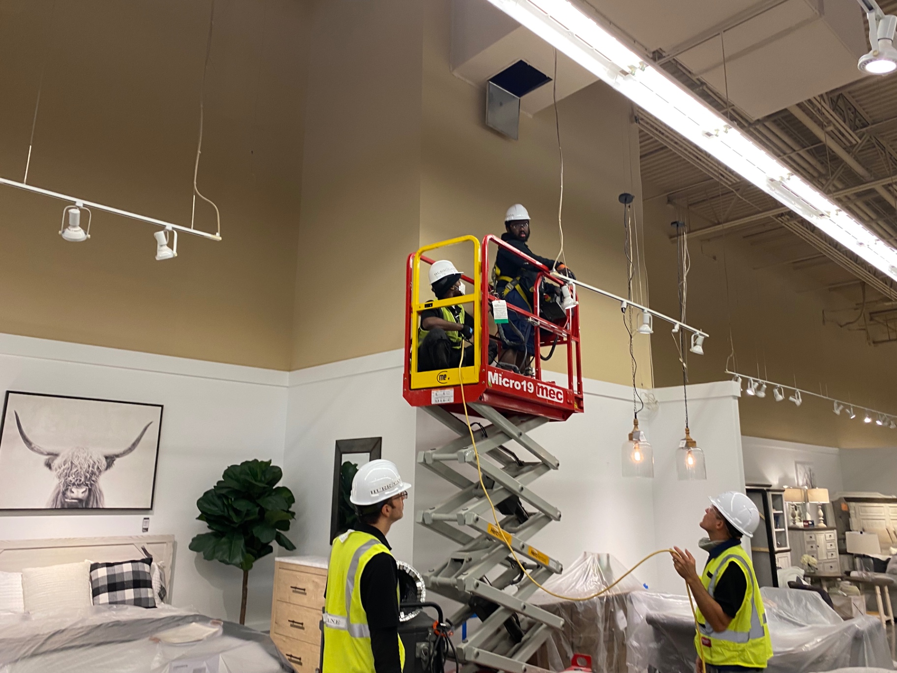 Ashley HomeStore — crew coordinating overhead service