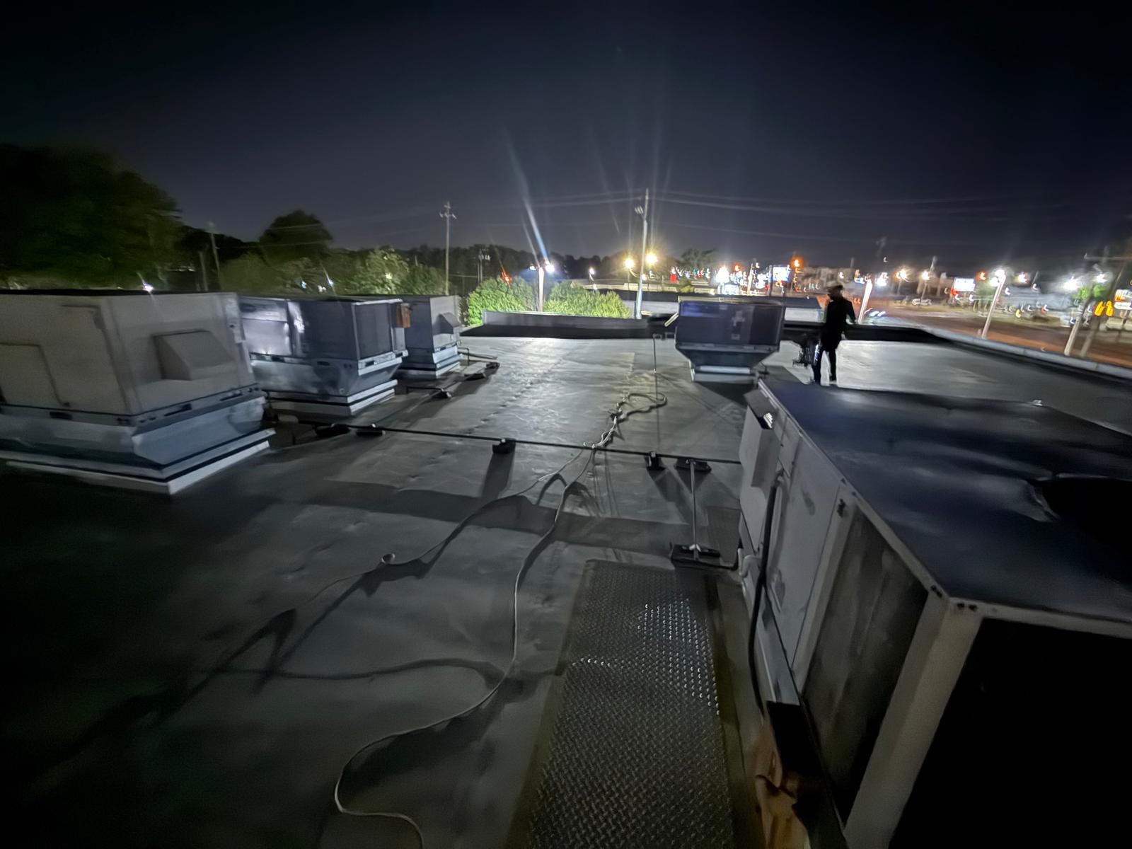 Office rooftop — packaged RTU service after-hours along the highway