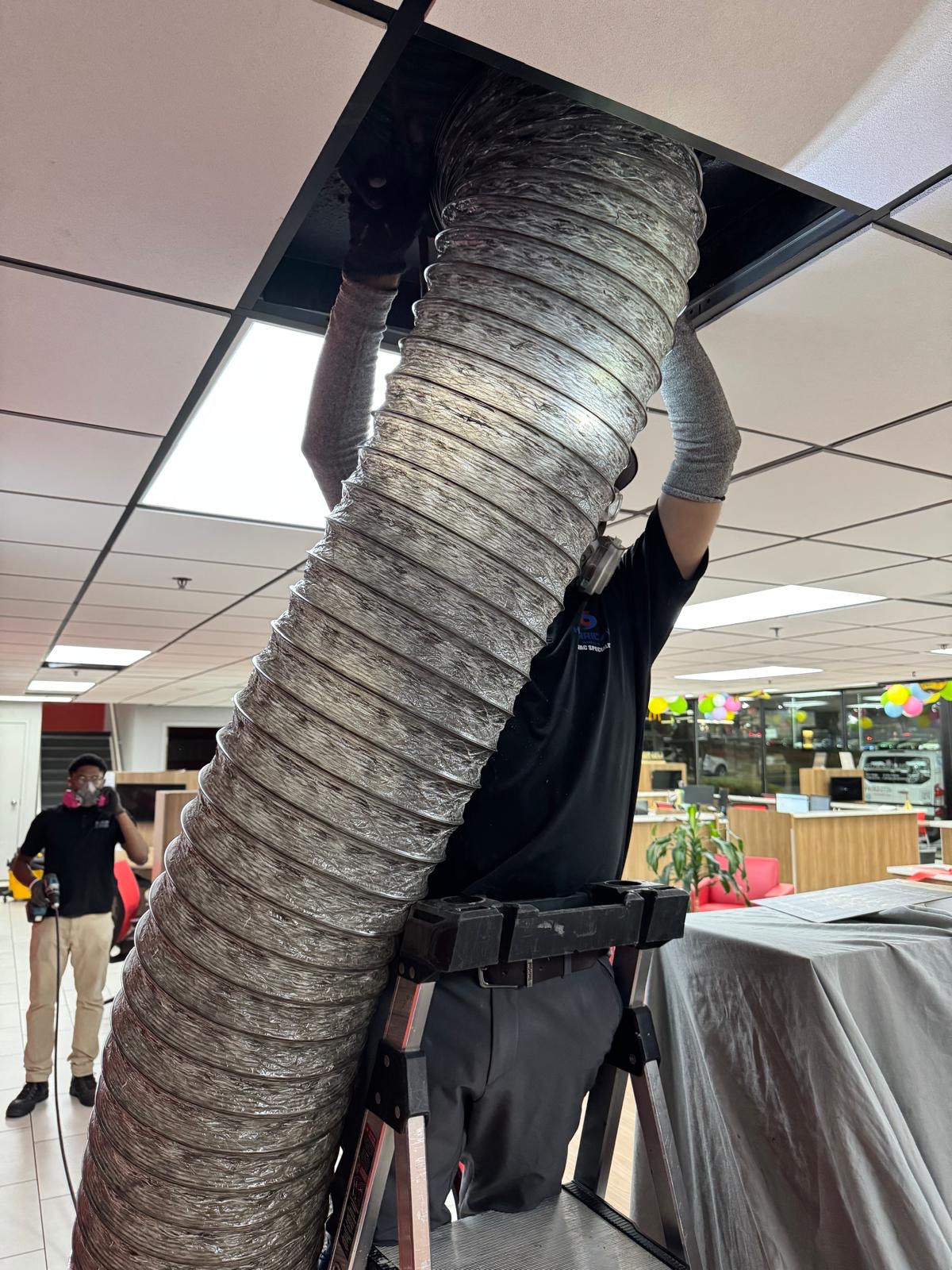 Dealership office — large-diameter duct access through ceiling tile