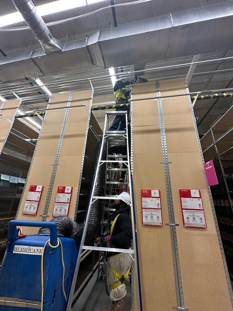 Backroom storage — overhead duct cleaning between stocked bays