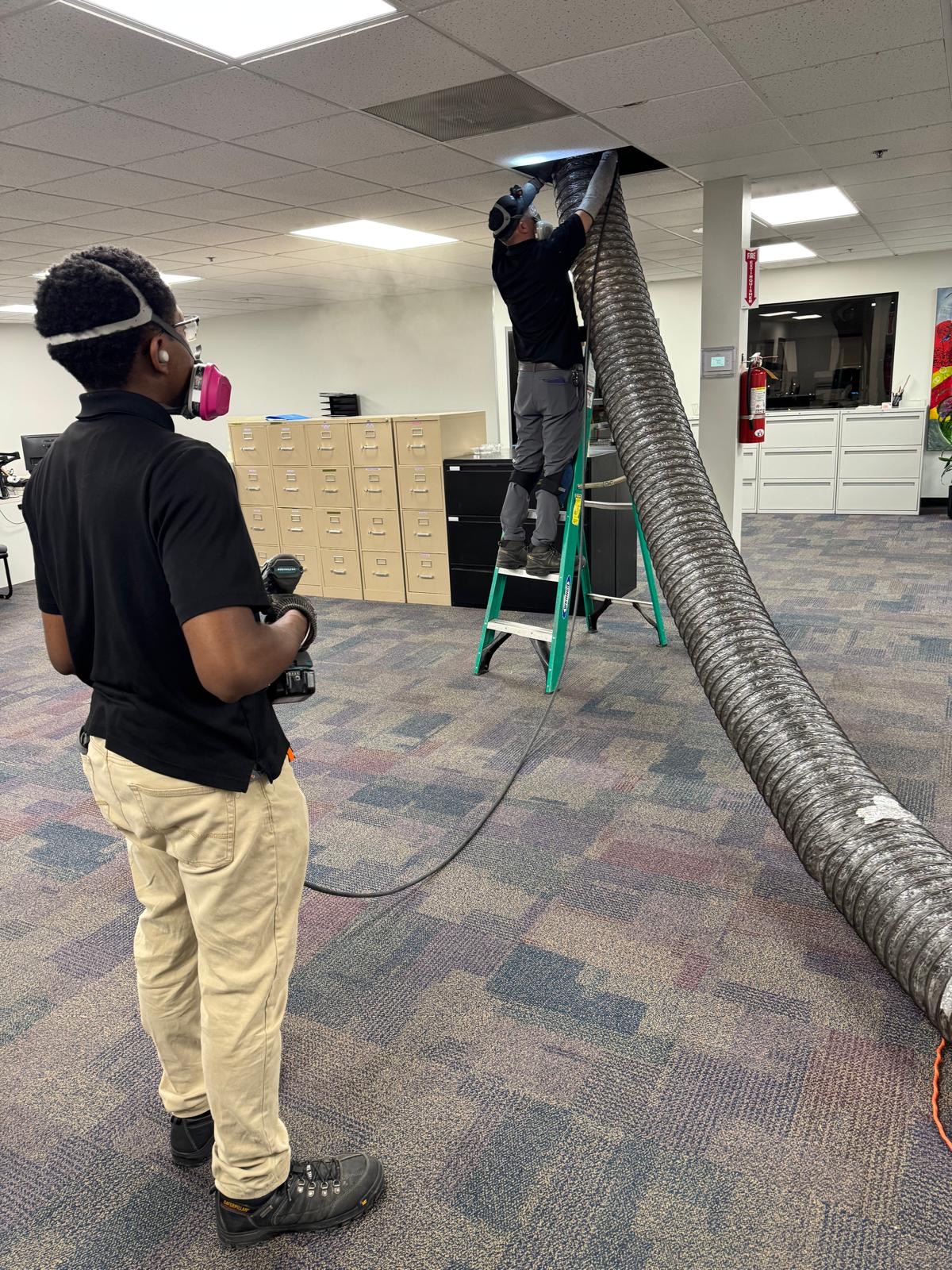 Open-plan office — agitation and HEPA vacuum across the trunk line