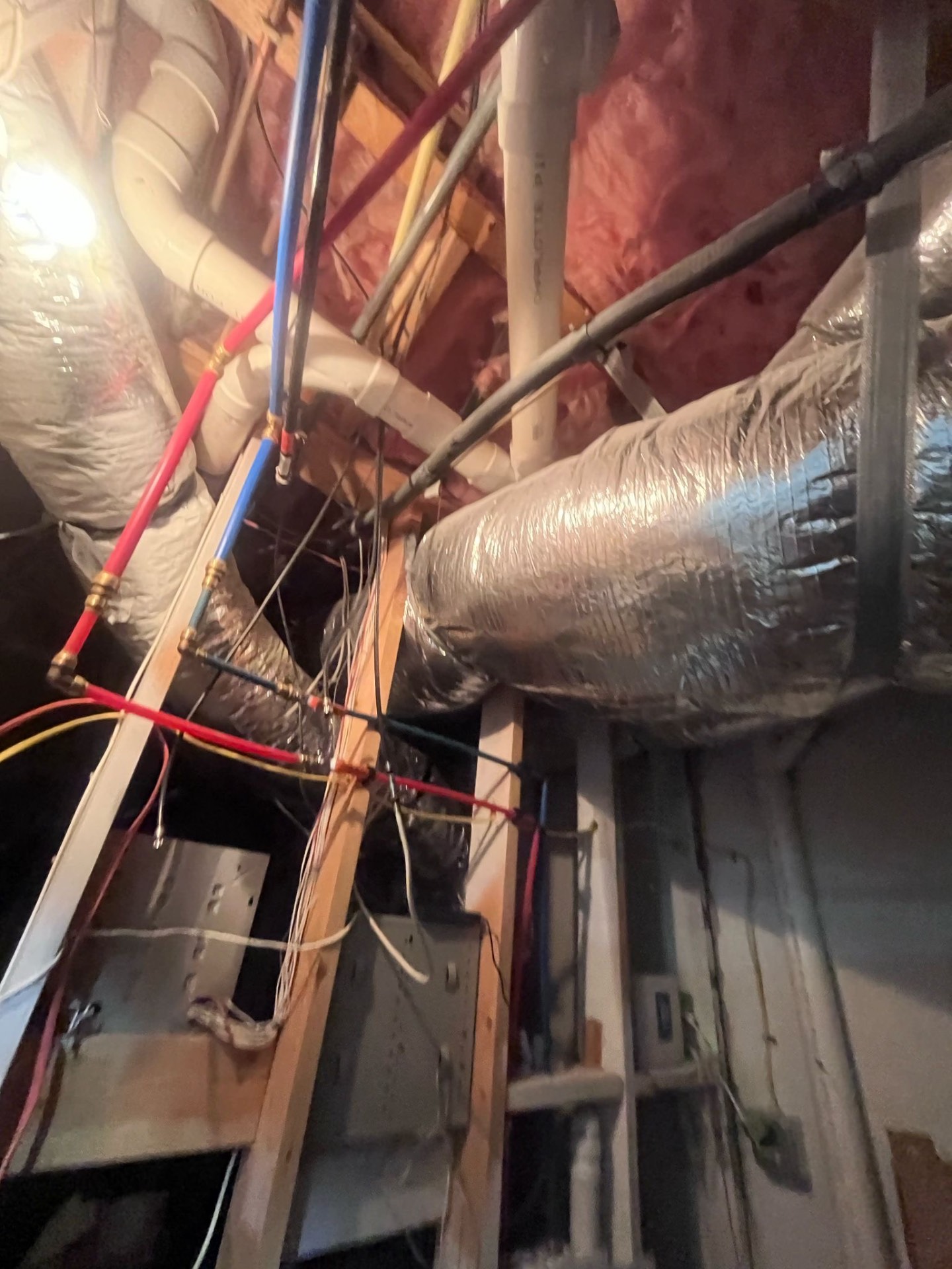 Fire station attic — insulated flex trunk lines, PEX water lines and electrical runs surveyed before duct cleaning