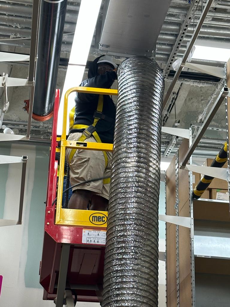 Storage facility — fall-protection harness work on overhead supply duct