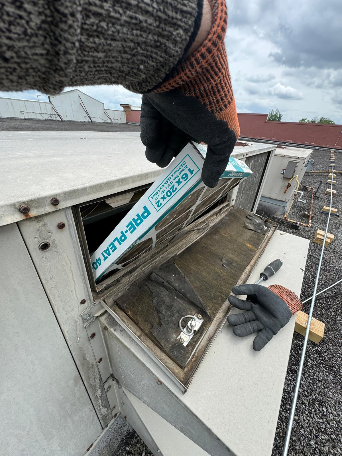 Rooftop filter change — fresh 16x20x2 pre-pleat installed in the RTU access door