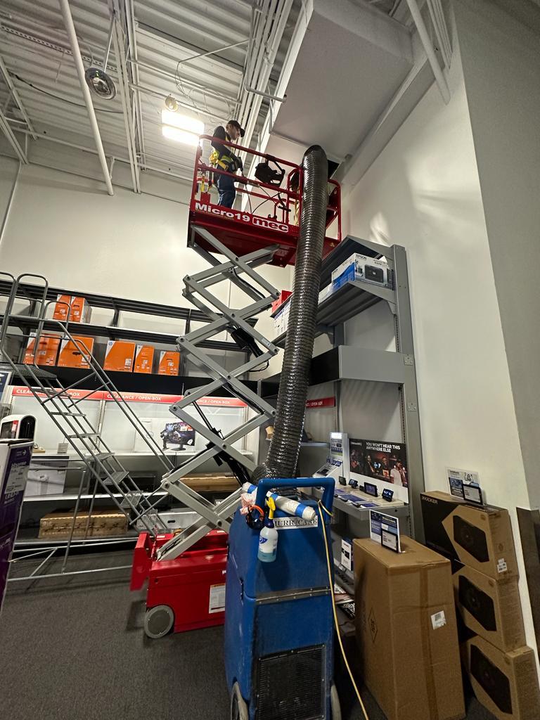 Electronics showroom — clearance aisle ceiling access at full lift height