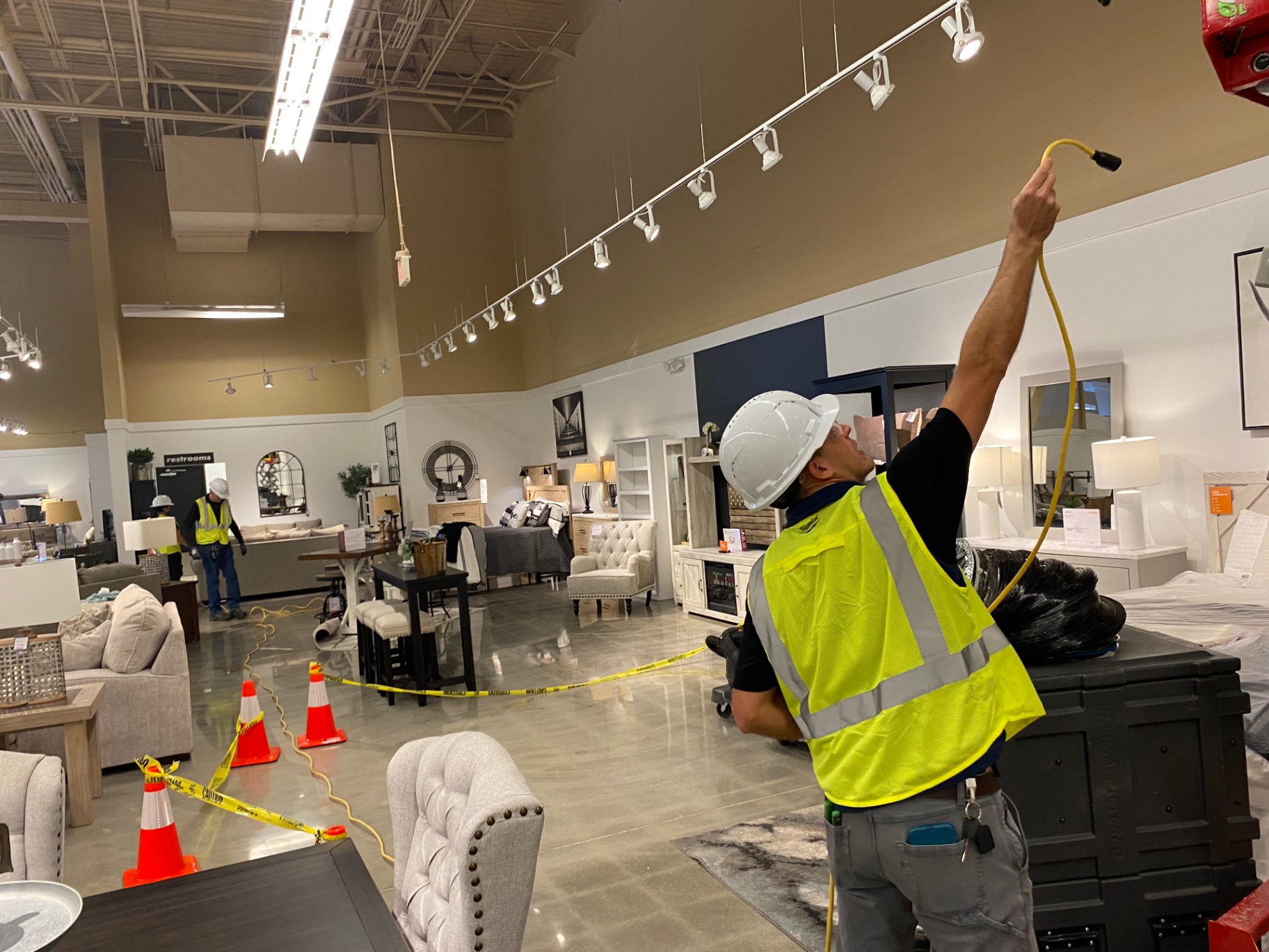 Ashley HomeStore — technician detailing ceiling line