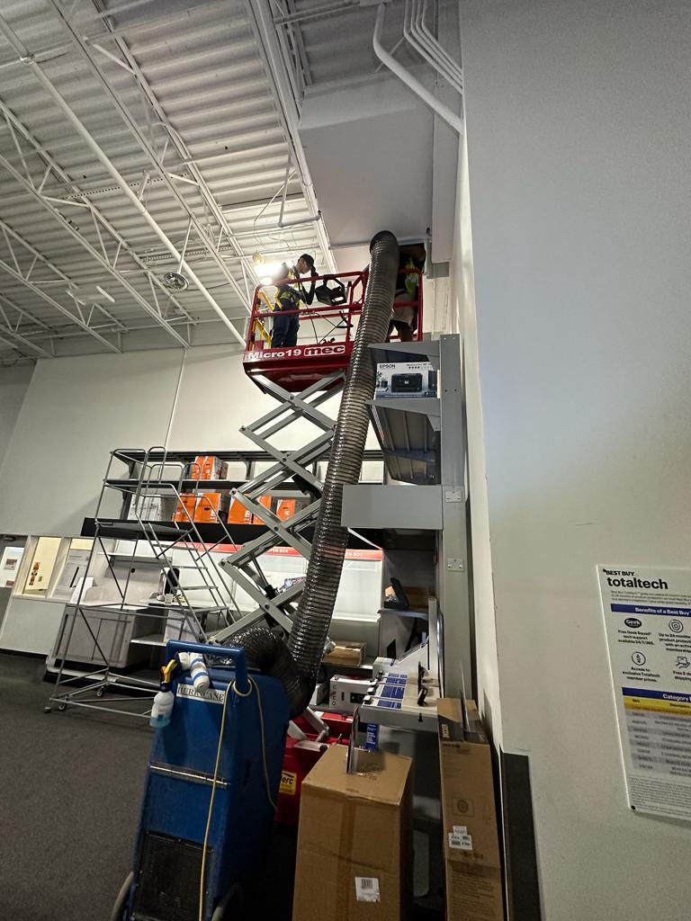 Electronics showroom — vertical duct cleaning beside Best Buy Totaltech wall